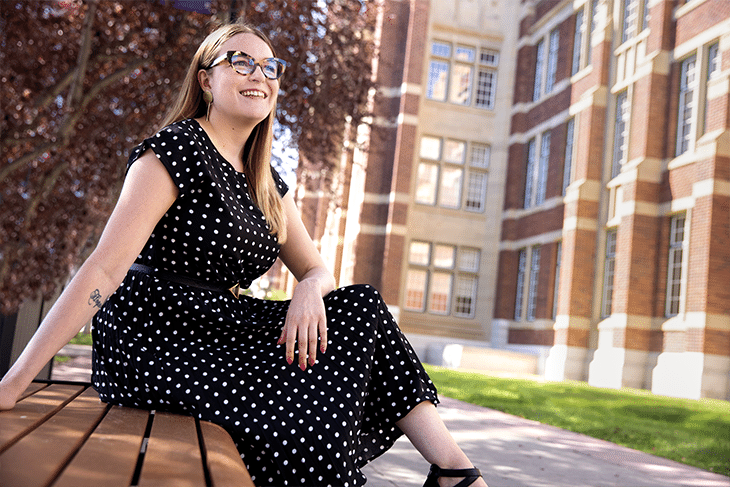 Woman in polka dot dress sitting on bench
