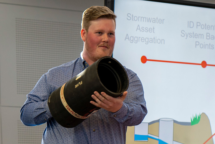 Smethurst holding up an example of a valve.