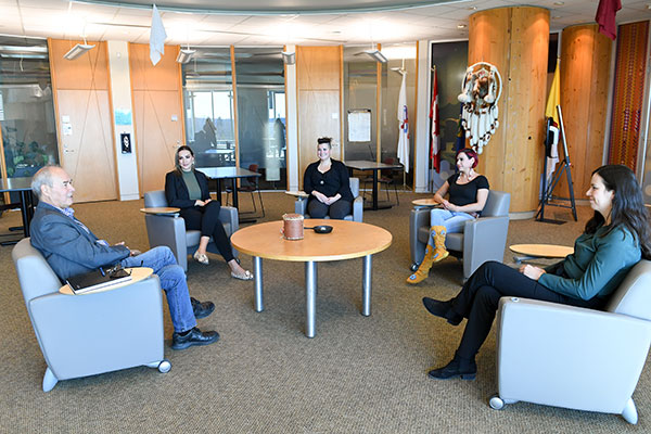 A group of Indigenous students have a meeting in Chinook Lodge. 