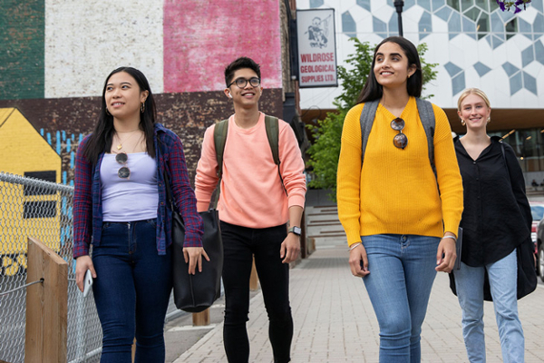 students smiling walking around downtown calgary