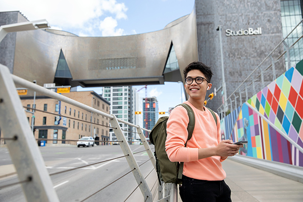 A SAIT student standing outside Studio Bell in downtown Calgary.