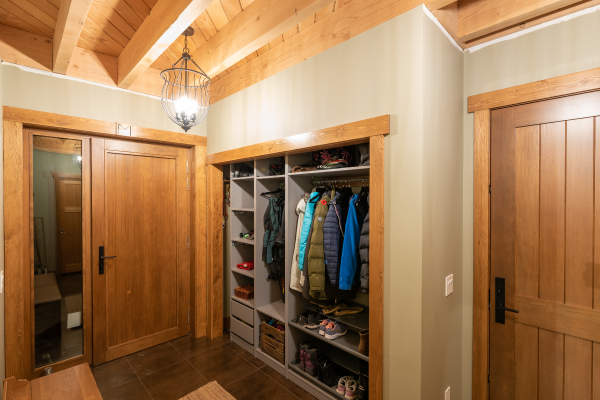 Featuring a custom, oversized fir front door, the tile and wood foyer provides a warm welcome to family and friends.