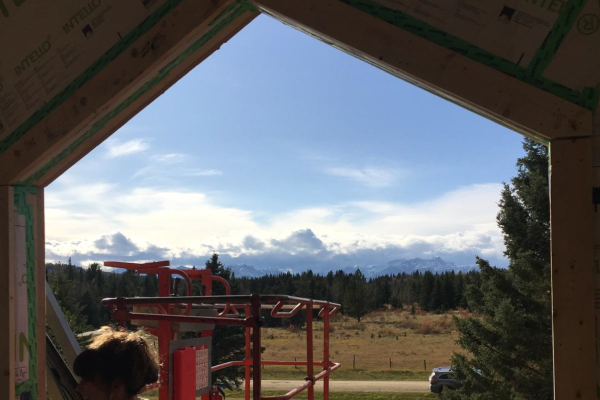 The view from the master bedroom, overlooking thick forestry and the Rocky Mountains.