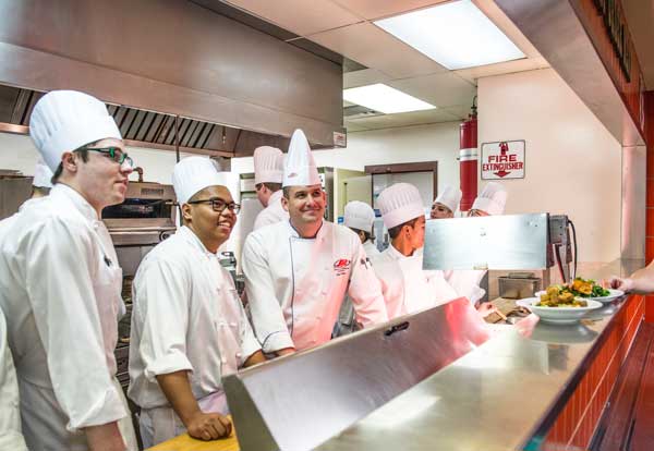 Students chefs pause to talk with their customers during lunch service at the 4 Nines Diner in the John Ware building