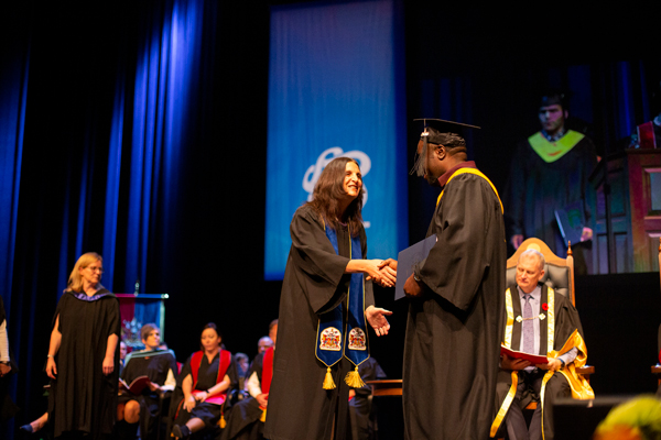Graduate handshake on stage