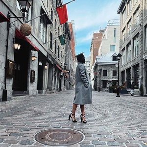 A woman wearing a graduation cap on the street