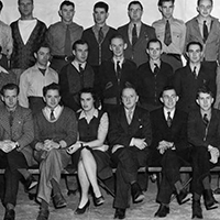 A group of men and women posing for a photo.