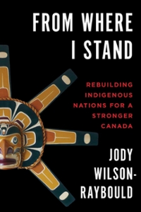 Book cover of From Where I Stand, with a wooden indigenous carving on the front of a black cover.