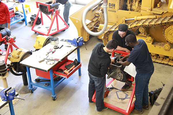 A group of people working on a motor