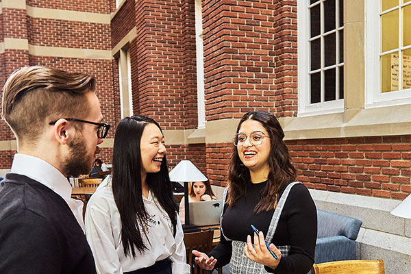 Three students chatting inside Stan Grad Centre