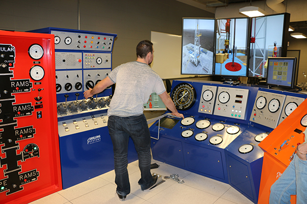 Person working on a drilling simulator in the lab.