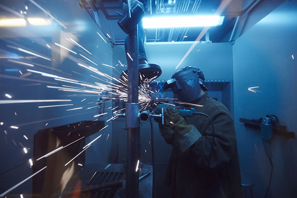 A student working in a welding booth