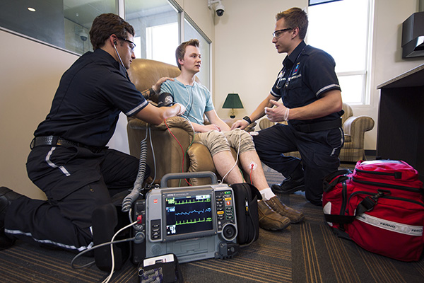 Students measure heart rate and blood pressure in a patient’s home.
