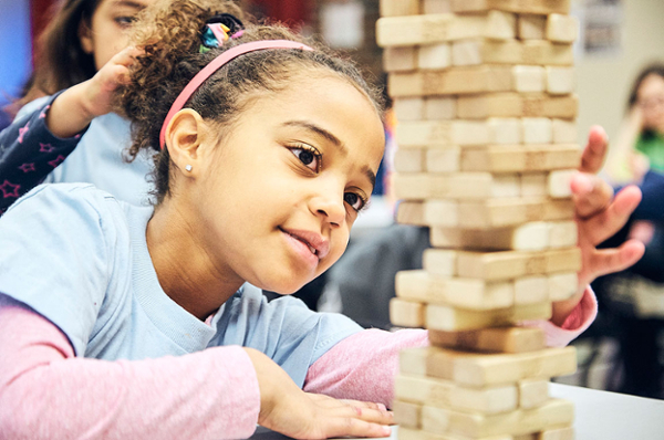 Young girl playing Jenga