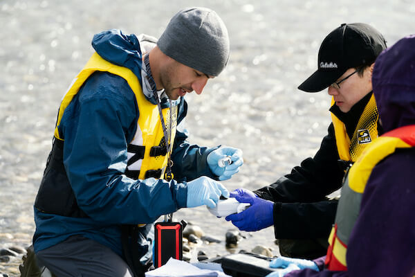 Two people collecting water samples